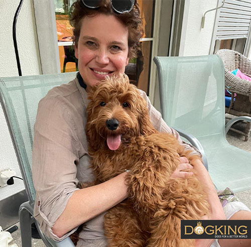 Woman smiling with her dog in her arms.