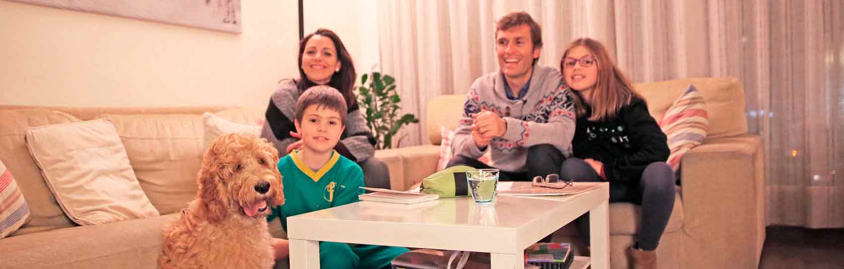 family with dog in the living room of the house